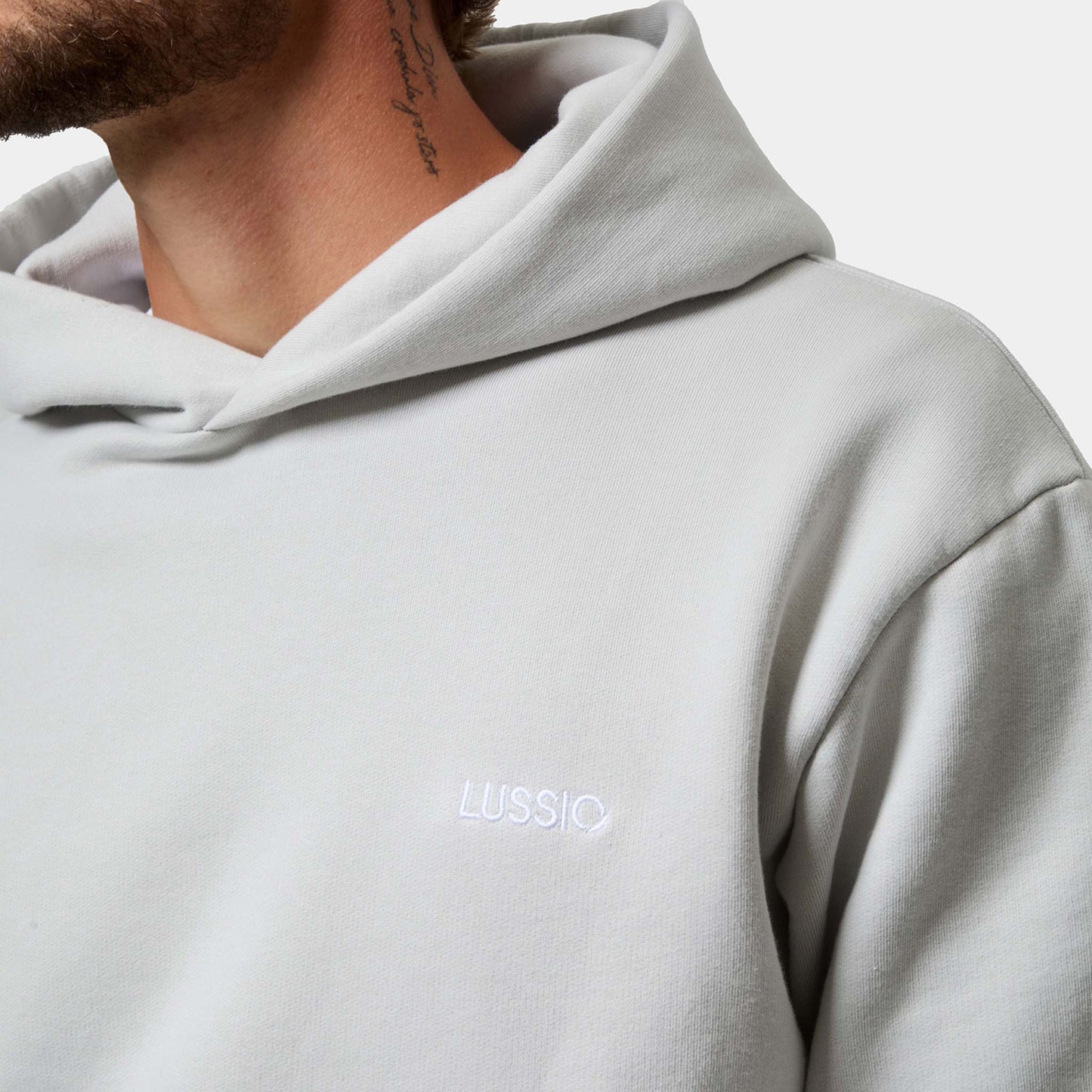 Close up shot of the lussio front logo on hoodie, and the hood shape, front view