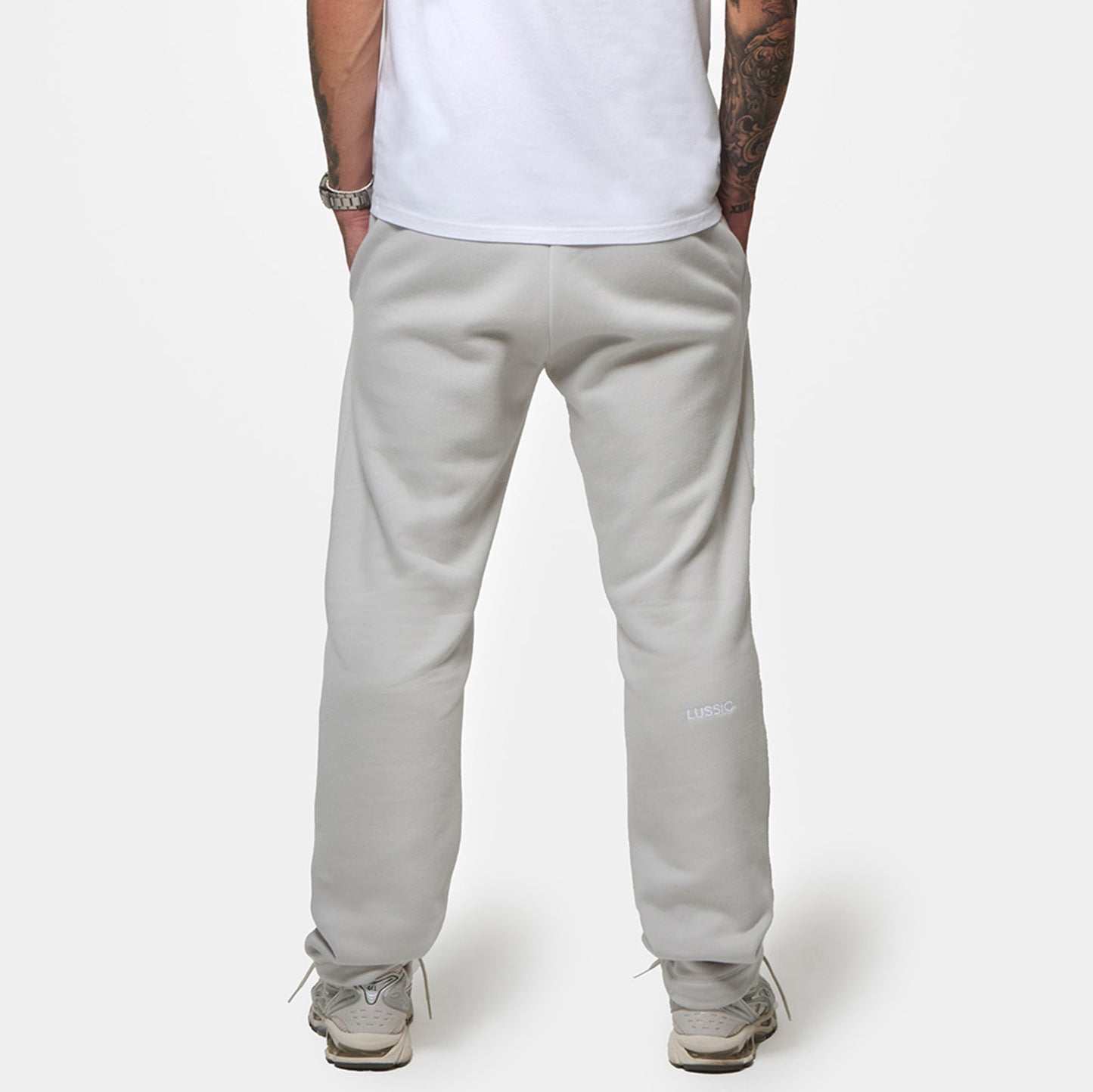 Close up shot of the model with his hands in both pockets, and showing the lussio back logo, back view