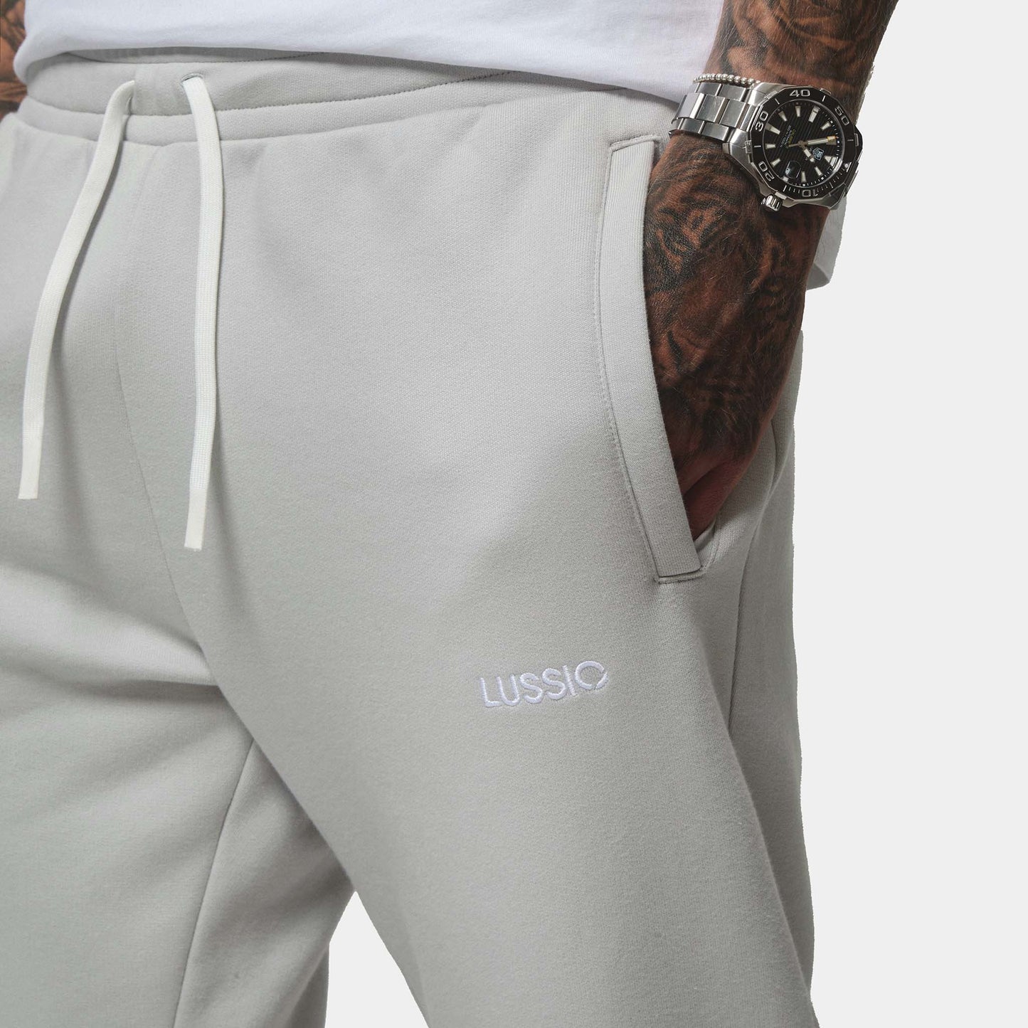 Close up on shot of the model with his hand in the pocket, and showing the lussio logo, front view