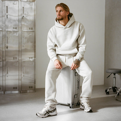 Model sat on a suitcase looking away from the camera, front view