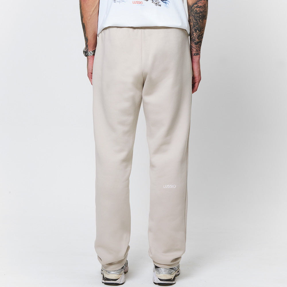 Close up shot of the model with his hands by his side, and showing the lussio back logo, back view