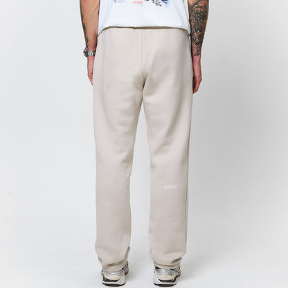 Close up shot of the model with his hands by his side, and showing the lussio back logo, back view